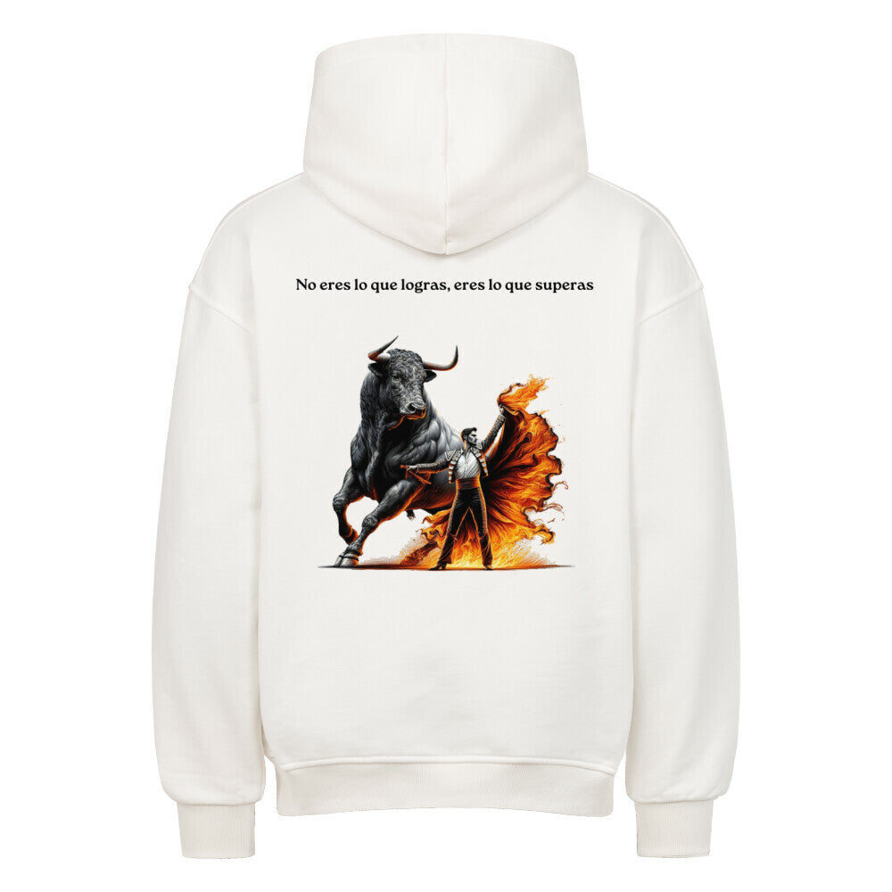 White oversized hoodie, back view, graphic print with bull illustration and Spanish quote “No eres lo que logras, eres lo que superas”