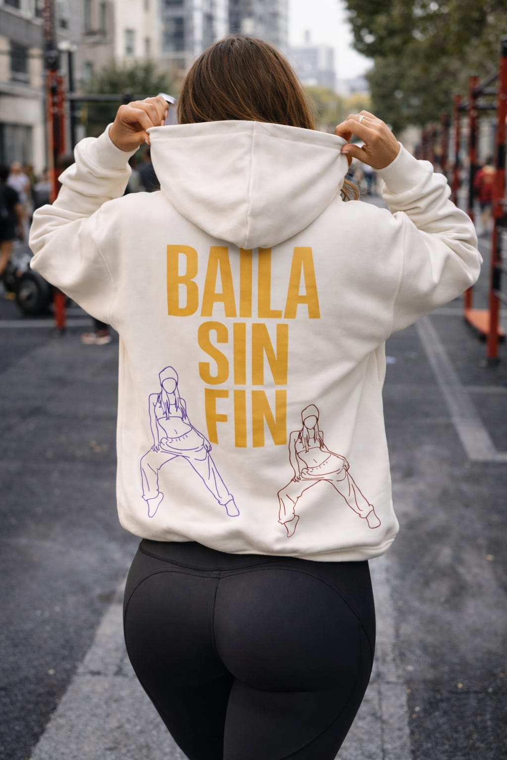Model wearing White oversized hoodie with print "Baila sin fin", back view