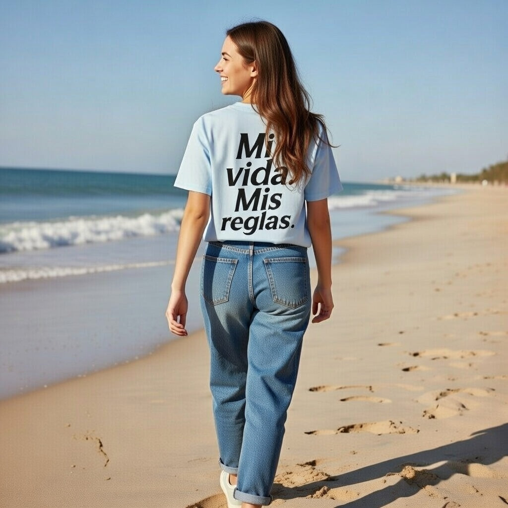Baby blue oversized t-shirt with “Mi vida. Mis reglas.” typography print, lifestyle beach scene